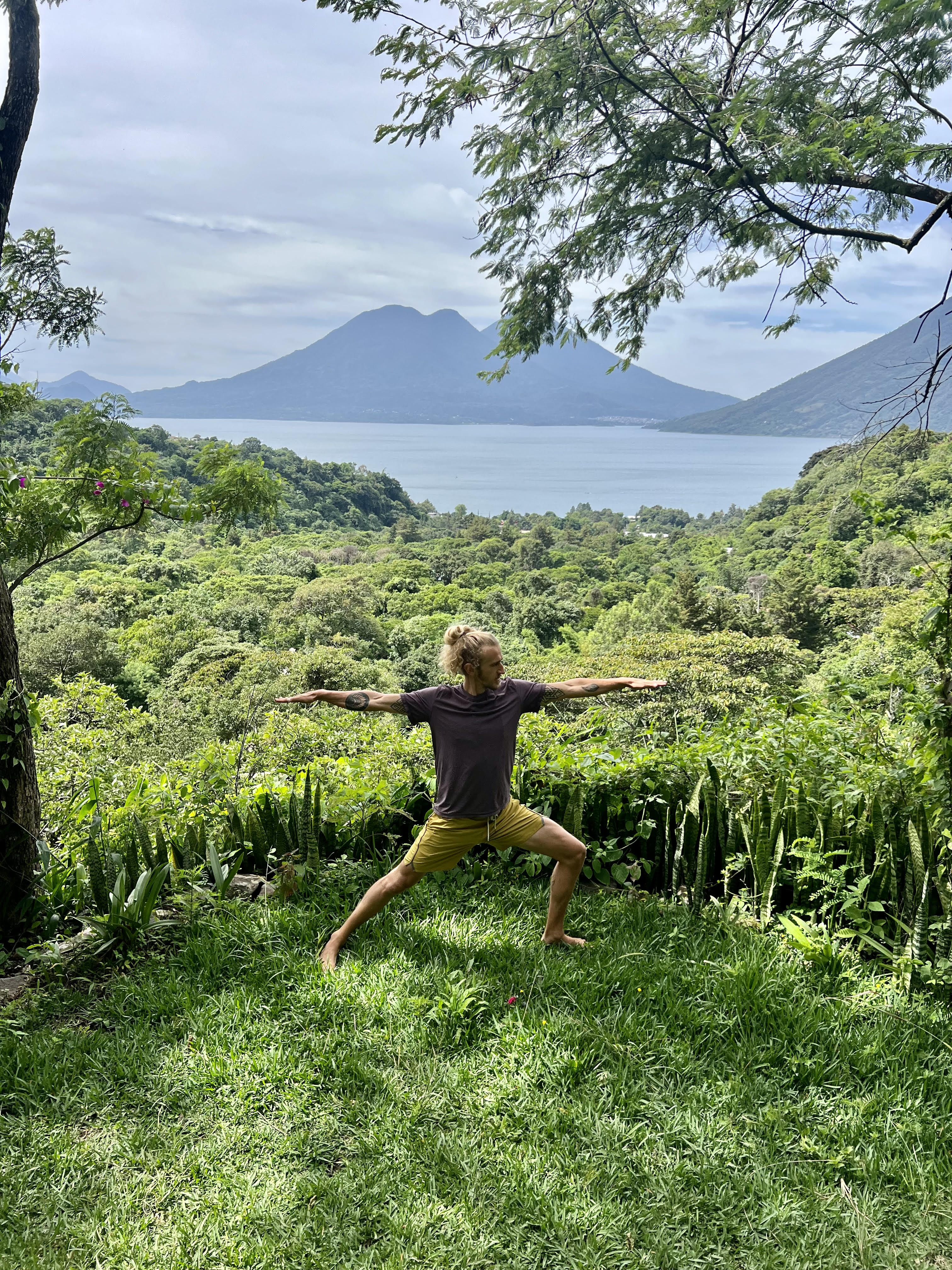 Warrior pose with Lake Atitlán backdrop